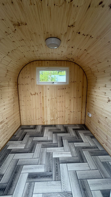 Finished garden office interior with ceiling light, socket and herringbone floor